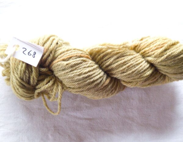 twisted skein of olive green yarn with darker brown flecks