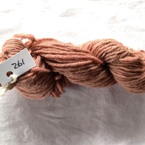 twisted skein of red brown yarn with a fewer redder or browner spots