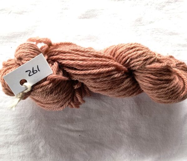 twisted skein of red brown yarn with a fewer redder or browner spots