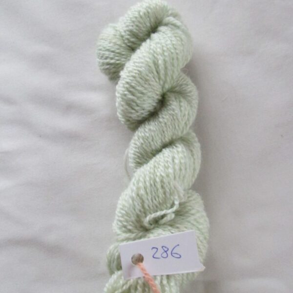 twisted skein of pale turquoise yarn on a white background with a label numbered 286