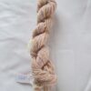 twisted skein of brown yarn on a white background with a label numbered 287