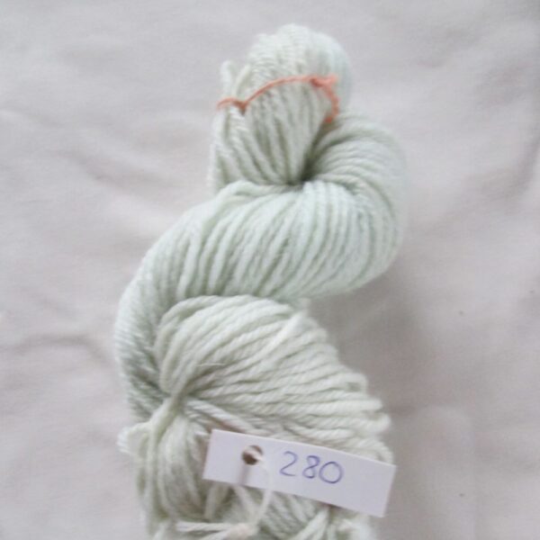 very pale blue skein of aran weight yarn on a white background with a label 280