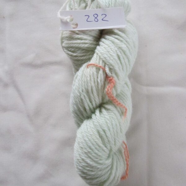 pale blue skein of aran weight yarn on a white background with a label 282