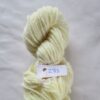 pale yellow skein of aran weight yarn on a white background with a label 283